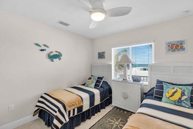 tiled bedroom featuring ceiling fan