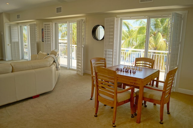 carpeted dining space with a healthy amount of sunlight