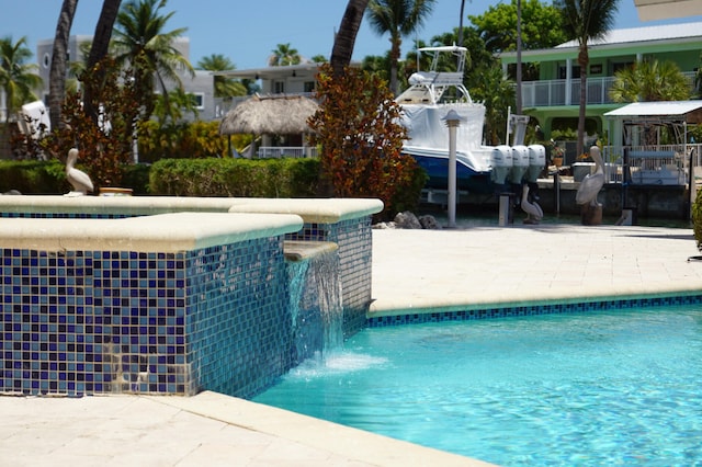 view of swimming pool with pool water feature