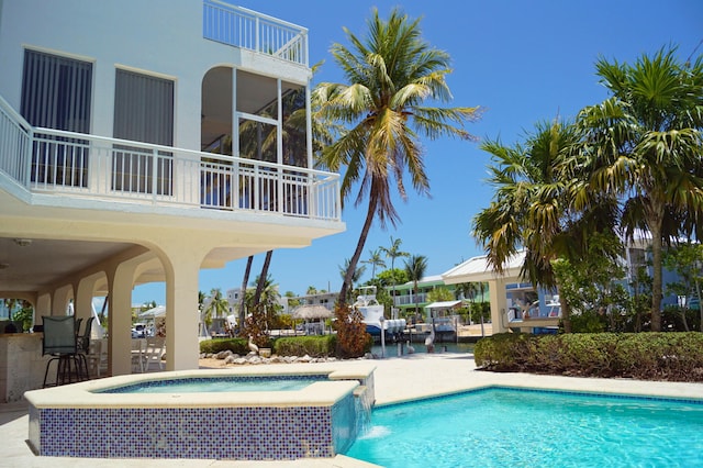 view of pool featuring an in ground hot tub and a patio