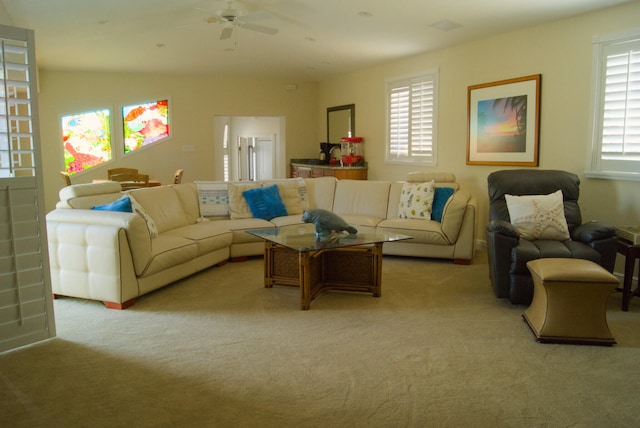 carpeted living room with a wealth of natural light and ceiling fan