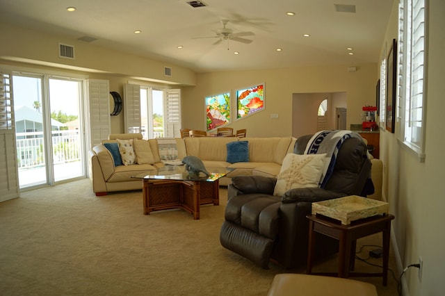 carpeted living room with ceiling fan