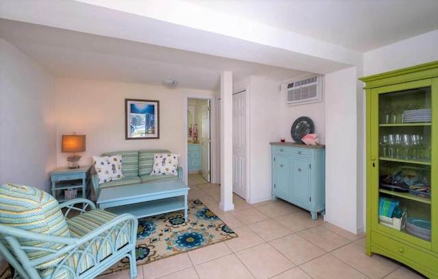 living room featuring light tile patterned flooring and a wall mounted AC