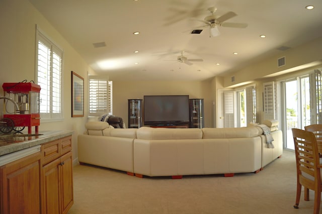 carpeted living room with ceiling fan and sink