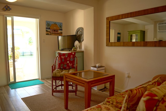 interior space with a wall mounted AC and light wood-type flooring