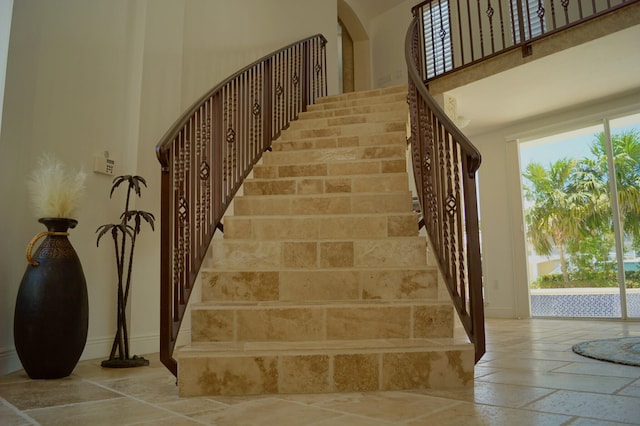 staircase featuring a high ceiling