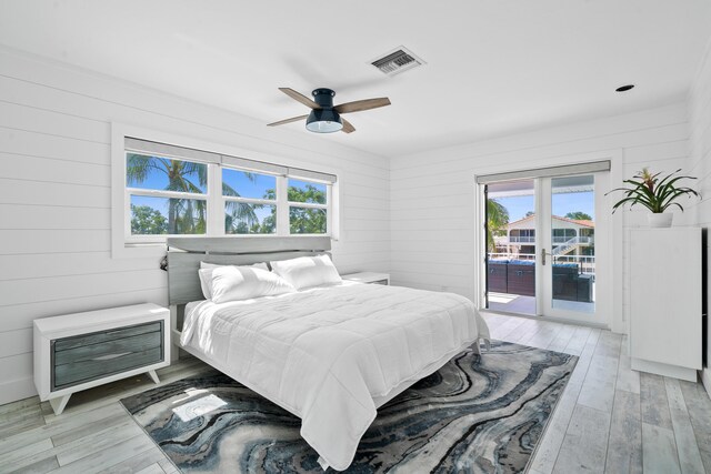 bedroom featuring ceiling fan, access to exterior, and light wood-type flooring