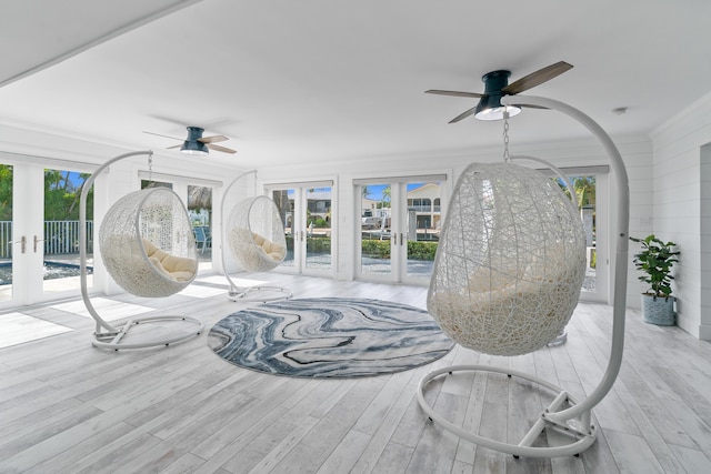 sunroom / solarium with a wealth of natural light, ceiling fan, and french doors