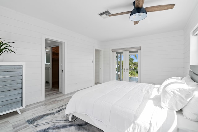 bedroom featuring light hardwood / wood-style flooring, access to outside, french doors, and ceiling fan