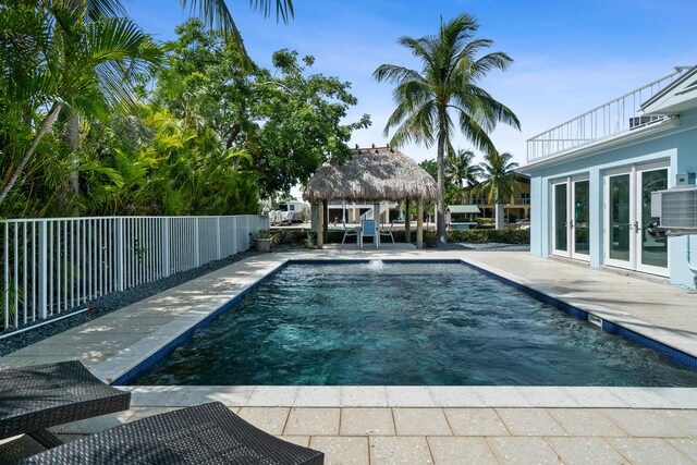 view of pool with central AC unit, a gazebo, and a patio