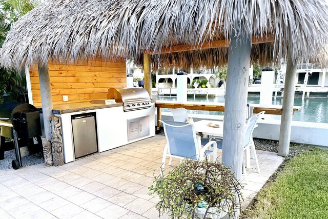 view of patio featuring a gazebo, area for grilling, grilling area, and exterior bar