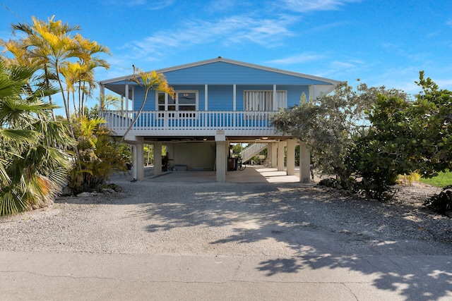 beach home with a carport and a porch