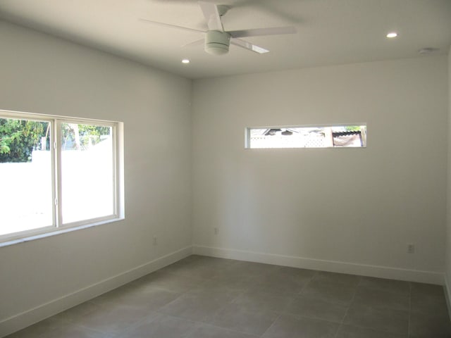 unfurnished room with tile patterned floors and ceiling fan