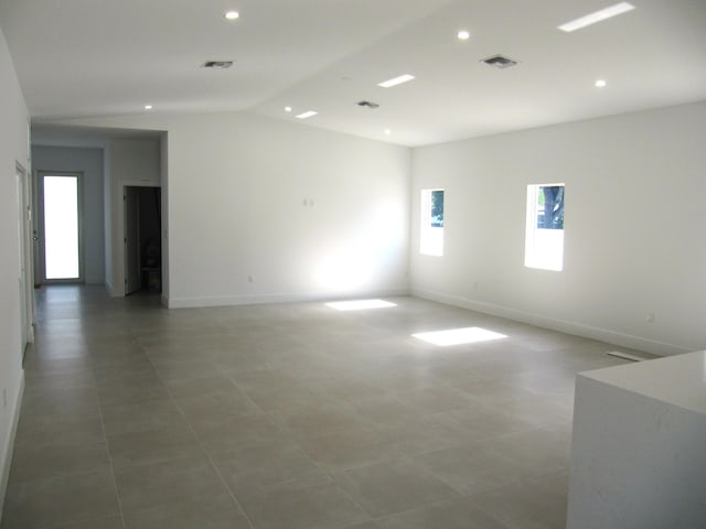 empty room featuring lofted ceiling