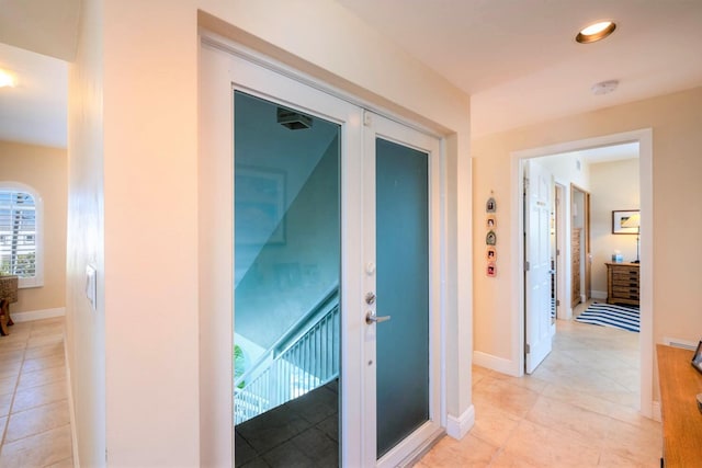 hallway featuring light tile patterned floors