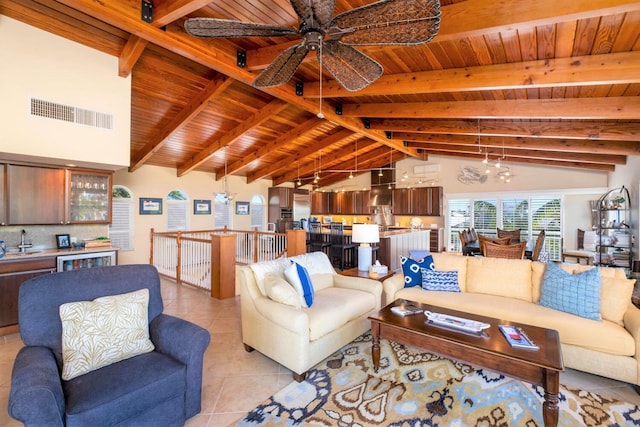 tiled living room featuring vaulted ceiling with beams, wooden ceiling, and ceiling fan