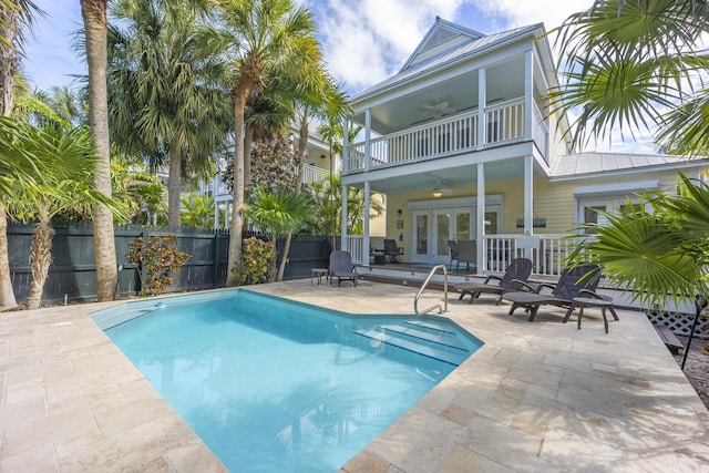 view of pool with a patio, french doors, and ceiling fan