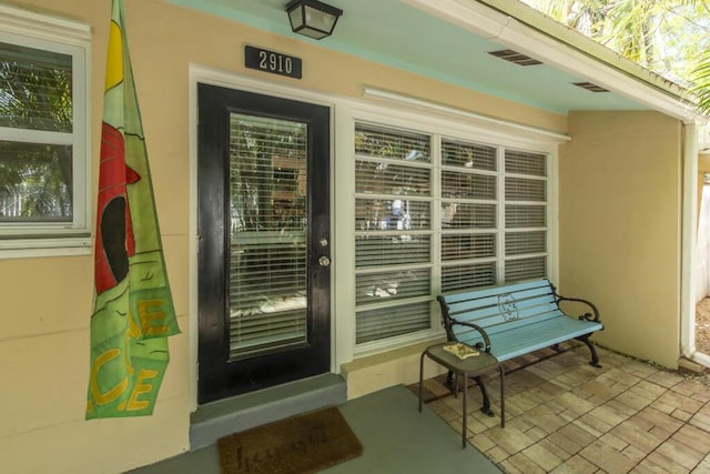 2910 Fogarty Ave, Key West, FL 33040 - property entrance with stucco siding and visible vents