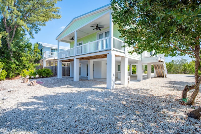 view of front of home featuring stairs, fence, and ceiling fan