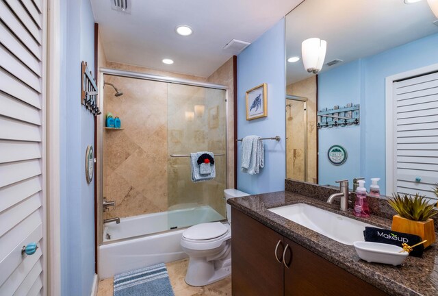 full bathroom with vanity, shower / bath combination with glass door, and toilet