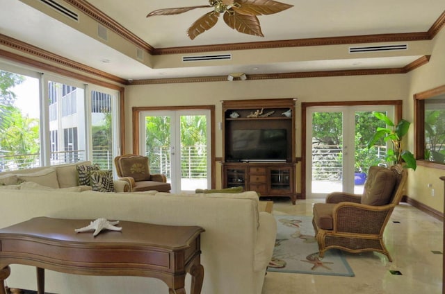 living room with ornamental molding and ceiling fan