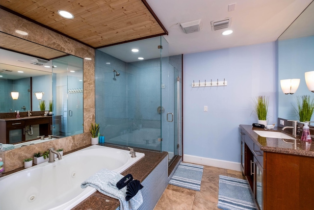 bathroom with vanity and independent shower and bath