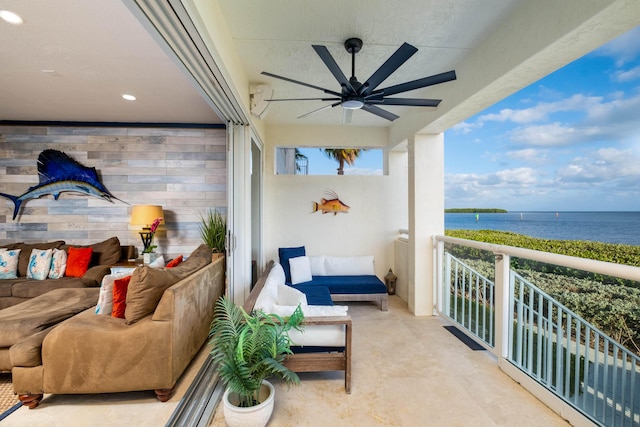 balcony featuring an outdoor living space, a water view, and ceiling fan