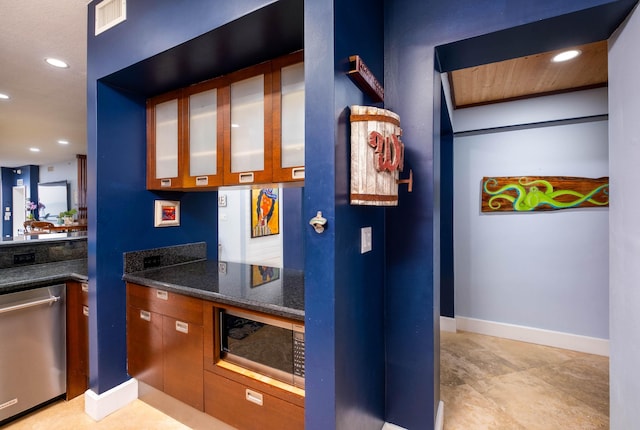 kitchen featuring appliances with stainless steel finishes and dark stone countertops