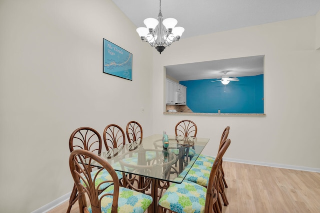 dining area featuring an inviting chandelier and light hardwood / wood-style floors