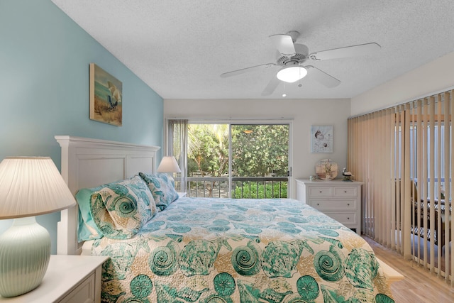 bedroom with ceiling fan, light hardwood / wood-style floors, a textured ceiling, and access to outside