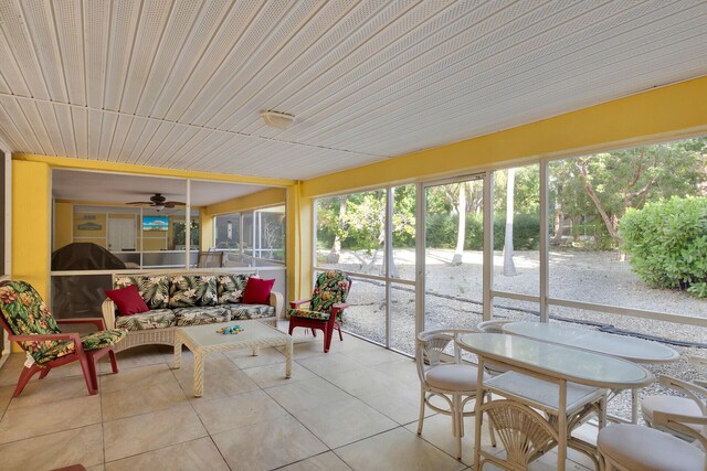 sunroom featuring ceiling fan