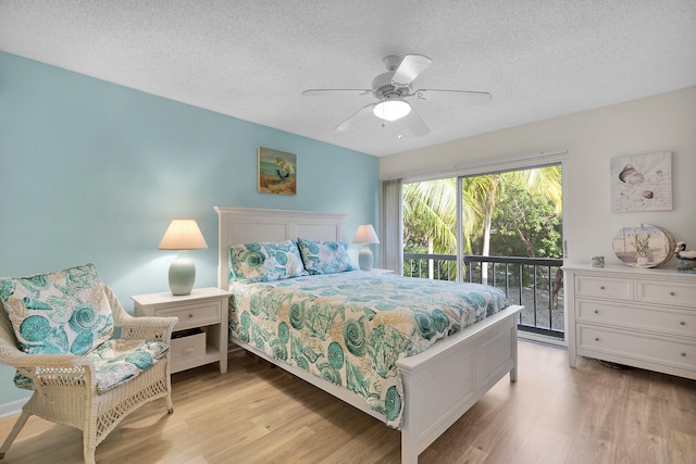 bedroom with ceiling fan, access to exterior, a textured ceiling, and light hardwood / wood-style flooring