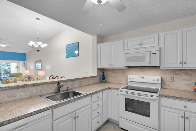 kitchen featuring white cabinetry, white appliances, sink, and hanging light fixtures