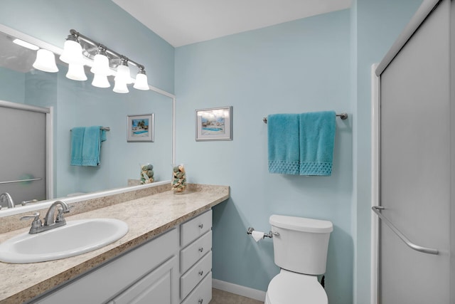 bathroom with vanity, an enclosed shower, and toilet