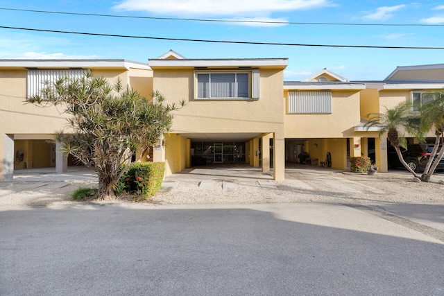 multi unit property featuring a carport