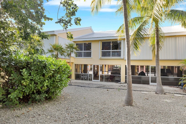 back of property featuring a sunroom