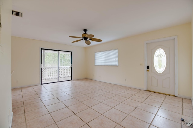 entryway featuring visible vents, ceiling fan, baseboards, and light tile patterned floors