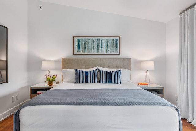 bedroom with hardwood / wood-style floors