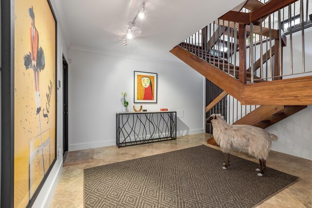 interior space with ornamental molding and rail lighting