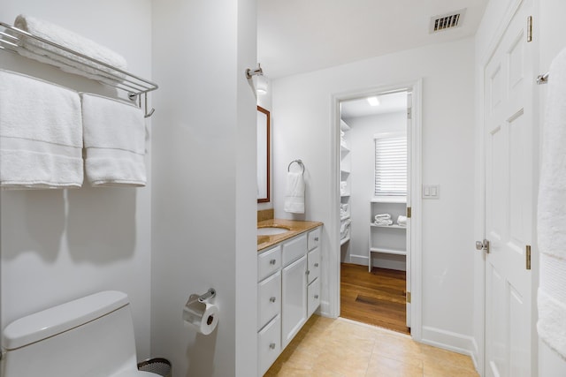 bathroom featuring tile patterned floors, vanity, and toilet