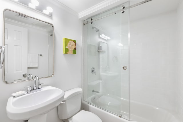 full bathroom featuring sink, bath / shower combo with glass door, ornamental molding, and toilet