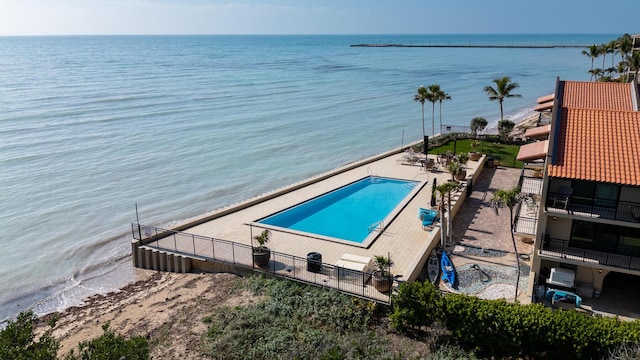 view of swimming pool with a water view