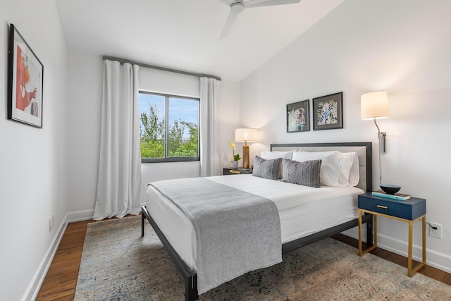 bedroom featuring vaulted ceiling, dark wood-type flooring, and ceiling fan