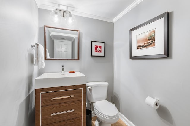 bathroom featuring vanity, ornamental molding, and toilet