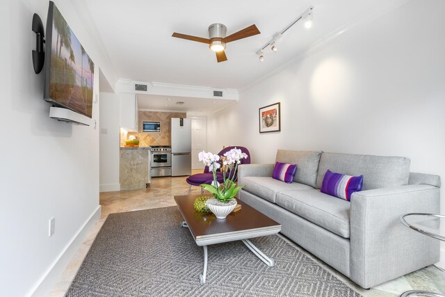 living room with ceiling fan, ornamental molding, and rail lighting