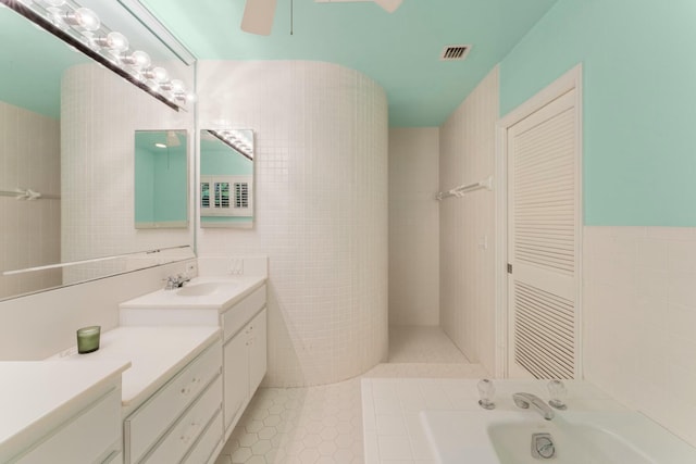 33 Pen Key Dr, Islamorada, FL 33036 - bathroom featuring tile patterned floors, tile walls, vanity, ceiling fan, and a washtub