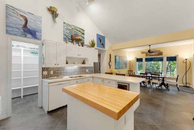 33 Pen Key Dr, Islamorada, FL 33036 - kitchen featuring sink, a center island, white dishwasher, kitchen peninsula, and white cabinets