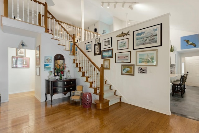 33 Pen Key Dr, Islamorada, FL 33036 - staircase with wood-type flooring, rail lighting, and high vaulted ceiling