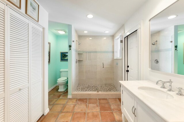 33 Pen Key Dr, Islamorada, FL 33036 - bathroom with vanity, tile patterned flooring, a shower with shower door, and toilet