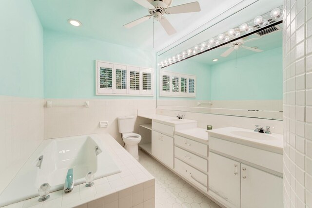 33 Pen Key Dr, Islamorada, FL 33036 - bathroom with tile patterned floors, toilet, vanity, a relaxing tiled tub, and ceiling fan